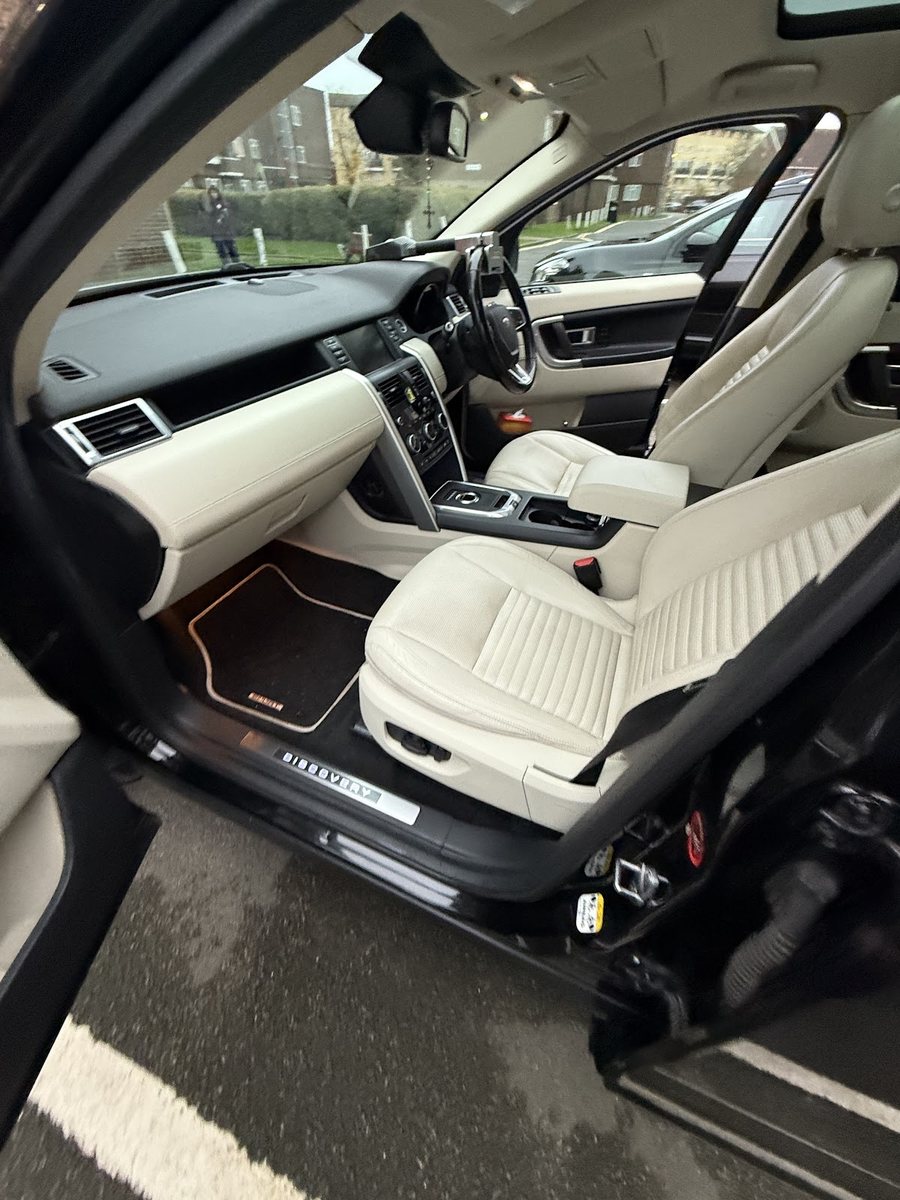 The cleaned interior of a car with cream leather seats